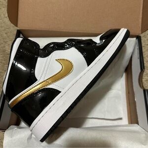Jordan Kids Black, White, and Gold Sneakers